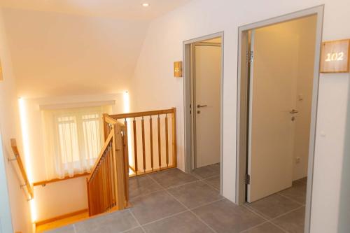 a hallway with two doors and a staircase in a house at Ferienhaus Schilcherland in Hochneuberg