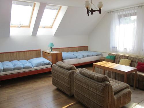 a living room with two beds and a couch at Apartmán Tisá 68 in Tisá