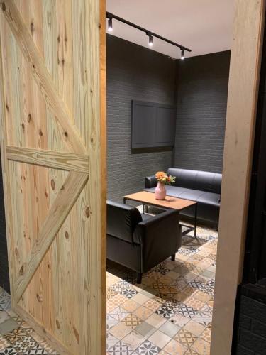 a sliding barn door in a room with a table at 弎TRINITY in Hengchun