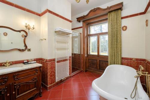 a bathroom with a toilet and a sink and a window at Resort Sobotín in Sobotín