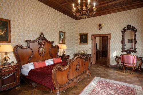 a bedroom with a bed and a chandelier at Resort Sobotín in Sobotín