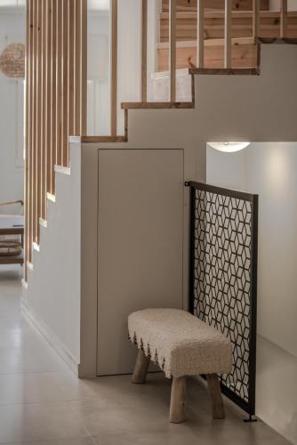 a bench in a hallway with a staircase at Cabanelli in Zakynthos Town