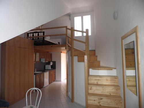 a staircase leading up to a room with a kitchen at Levandule in Brno