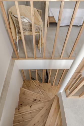 an attic room with a bed and wooden floors at Cabanelli in Zakynthos Town