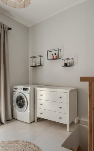 a laundry room with a washer and a washing machine at Cabanelli in Zakynthos Town