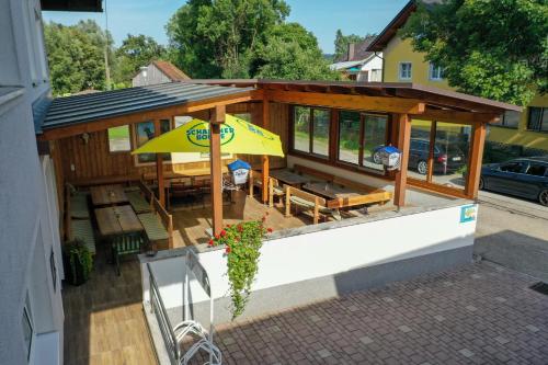 an overhead view of a house with a patio with an umbrella at Gasthof-Pension Riedl in Vöcklamarkt