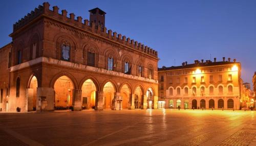 a large brick building with lights on it at night at Casa Vacanze Rosignoli in Cremona