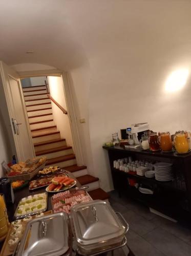 a kitchen with a table with food on it at Hotel Svambersky dum in Český Krumlov