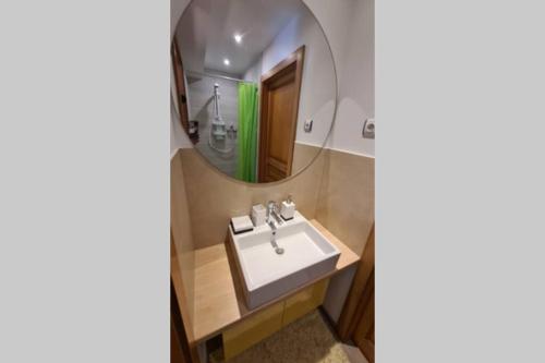 a bathroom with a sink and a mirror at chic t3 60 m2 cosy 1 a 6 personnes rando, nature, bike park, station de ski in Le Bonhomme