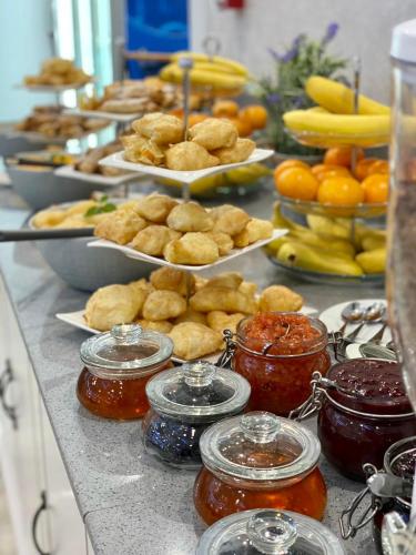 a buffet with many plates of food and fruit at Imperial Hotel&Spa - Baile Olanesti in Băile Olăneşti