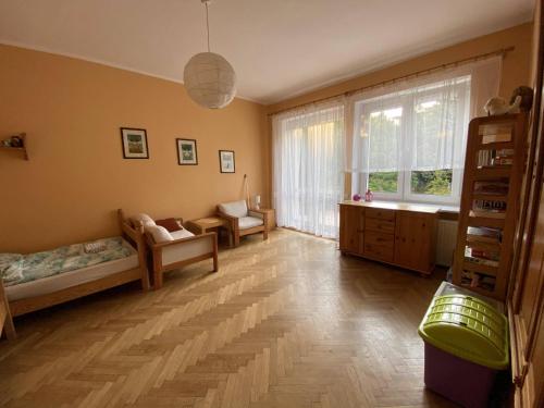 a living room with a large window and a couch at Pokoje Gościnne Hetmanska in Gdynia