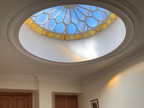 a skylight on a ceiling with a stained glass window at Heathpark House in Blairgowrie