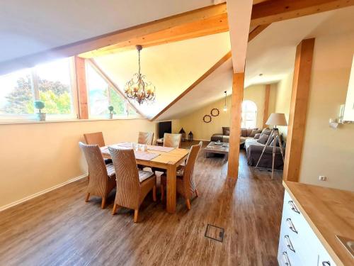 a dining room and living room with a table and chairs at Ferienwohnung Kaiserblick in Grassau