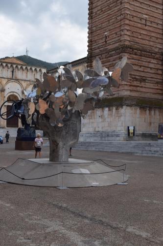 a sculpture of a tree in front of a building at CB House Tuscany in Pietrasanta