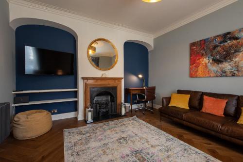 a living room with a couch and a fireplace at Crossgate in Durham