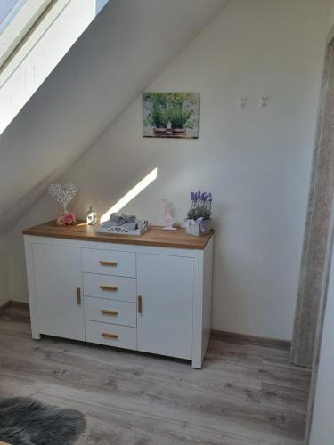 a white dresser in a room under a staircase at Apartmán Bobo in Stožok