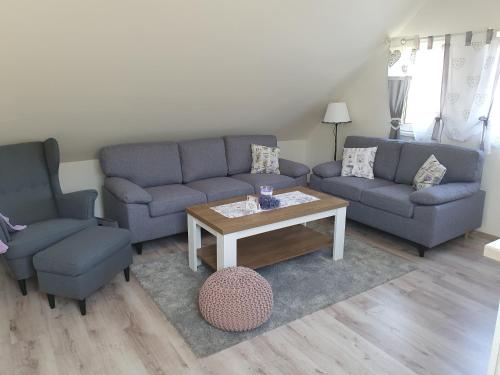 a living room with two couches and a coffee table at Apartmán Bobo in Stožok