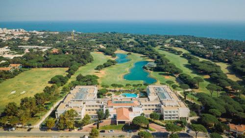 an aerial view of a large building with a lake at Onyria Quinta da Marinha Hotel in Cascais