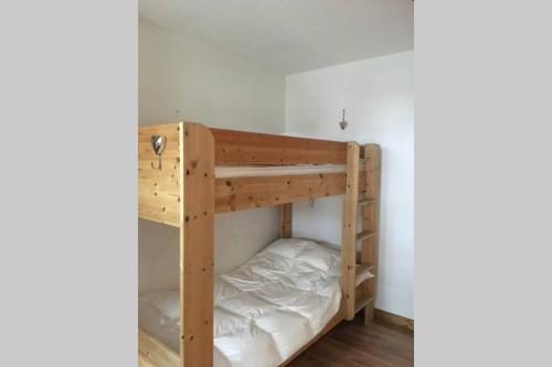 a bunk room with two bunk beds in it at Charmant appartement, centre ville, vue Mont-Blanc in Chamonix