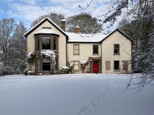 a house with snow on the ground in front of it at Heathpark House in Blairgowrie