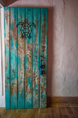 a blue wooden cabinet in a room with a wall at Hotel El Delfin in Monterrico