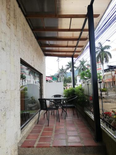 a patio with a table and chairs on a balcony at HOTEL COSTA DEL SOL FUSAGASUGa in Fusagasuga