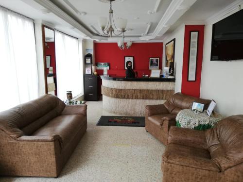 a living room with two couches and a bar at HOTEL COSTA DEL SOL FUSAGASUGa in Fusagasuga