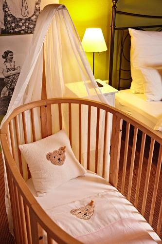 a crib with two bear pillows in a bedroom at Schittlerhaus in Oberstdorf