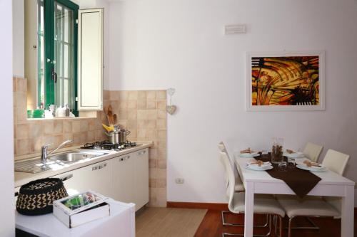 a kitchen with a sink and a table and a table and a sink at La Casetta di Renato in Mormanno