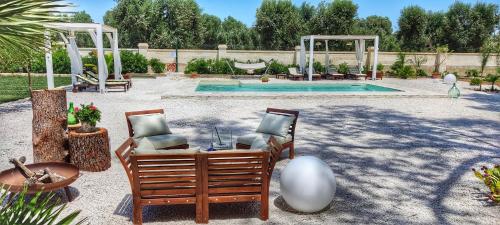 um pátio com 2 cadeiras e uma piscina em B&B Sogno Salentino em Lizzano