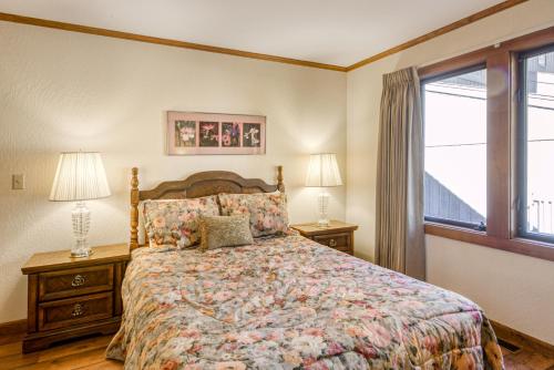 a bedroom with a bed and two lamps and a window at Skyland Retreat - Max nighttime occupancy of 8 in Zephyr Cove