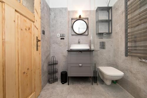 a bathroom with a sink and a toilet at Apartamenty Stara Apteka in Stronie Śląskie