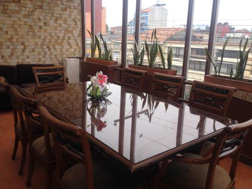a dining room table with two chairs and a table cloth at Hotel AW Boutique in Bogotá