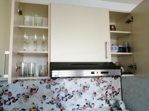 a kitchen with white cabinets and a stove top oven at Slávik Apartment in Dunajská Streda