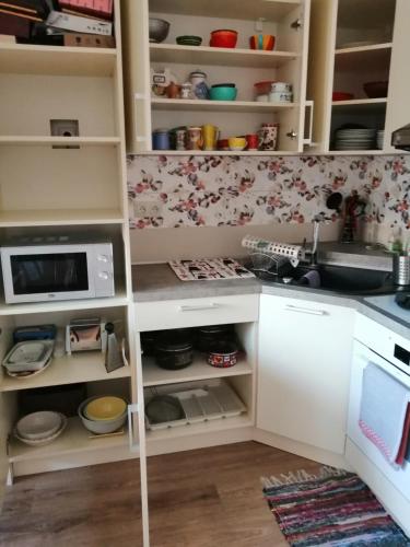 a kitchen with white cabinets and a sink at Slávik Apartment in Dunajská Streda