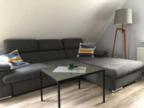 a living room with a couch and a coffee table at Ferienwohnungen Margot in Iserlohn