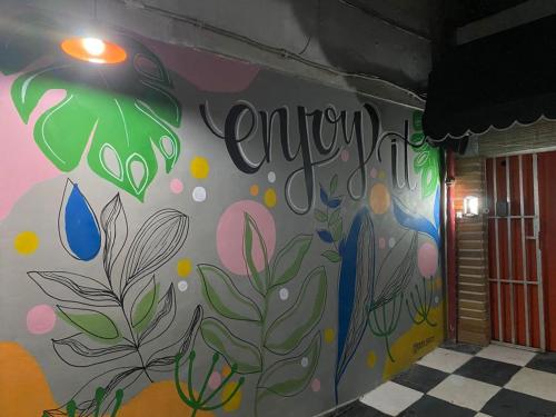 a wall with a painting on the side of a building at Ipanema Club Hostel in Rio de Janeiro