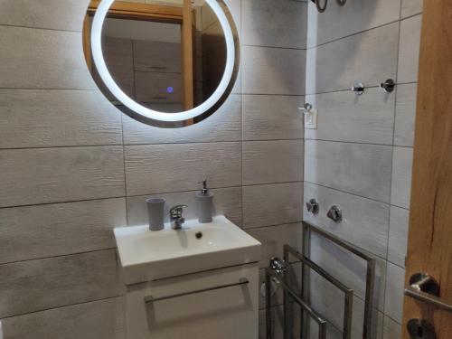 a bathroom with a sink and a mirror at Athina View Studio in Néa Péramos