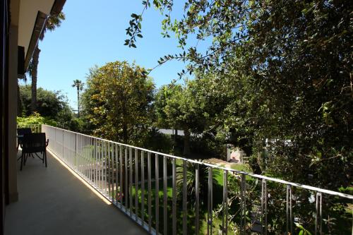 a balcony with a white fence and trees at Villa Vanessa in Fregene