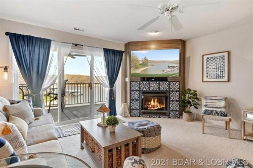 a living room with a couch and a fireplace at Family Fun Lakefront Condo at Parkview Bay in Osage Beach