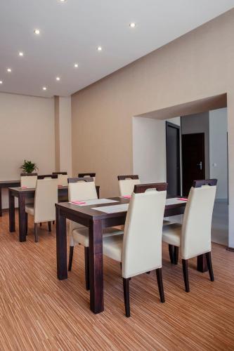a conference room with a table and white chairs at Boutique Hotel's Bytom in Bytom