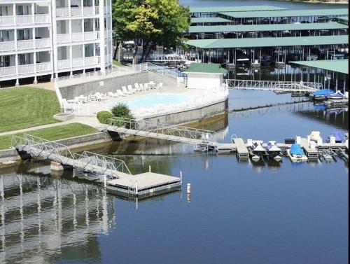 a marina with chairs and a dock in a building at Family Fun Lakefront Condo at Parkview Bay in Osage Beach