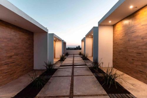 an empty hallway of a house with a brick wall at Collins Village Hotel Boutique in El Porvenir