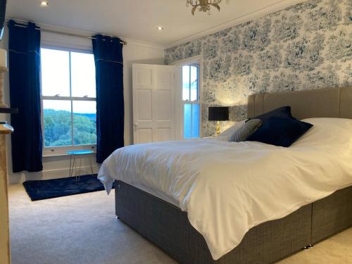 a bedroom with a large bed and a window at Penyvoel Hall in Llanymynech