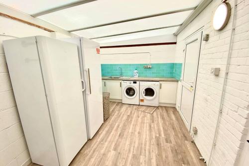 a laundry room with a washer and dryer in it at Cleveland House - Perfect for Beaches and Town. in Bournemouth