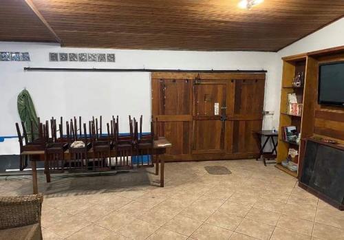 a room with a table and chairs and a television at Ipanema Club Hostel in Rio de Janeiro