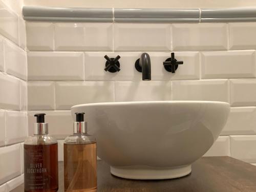 a white sink and two bottles on a counter at Heathpark House in Blairgowrie