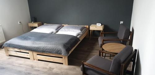 A bed or beds in a room at OÁZA PENZIÓN