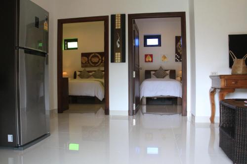 Ένα ή περισσότερα κρεβάτια σε δωμάτιο στο Arthaya Villas - SHA Extra Plus