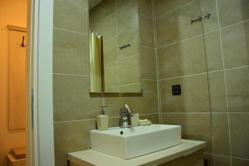 a bathroom with a white sink and a mirror at Apartman Suny N58 in Kopaonik